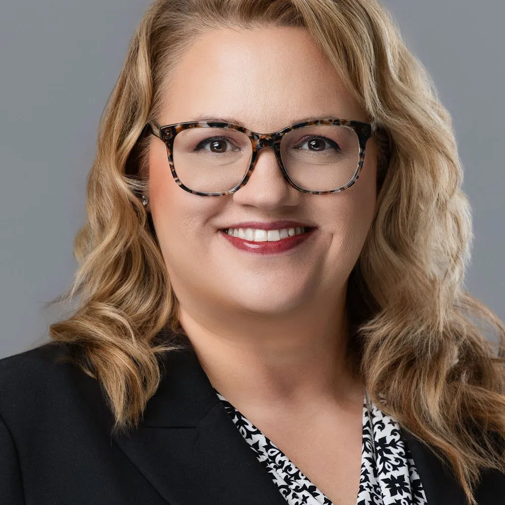 Corporate headshot on a gray backdrop