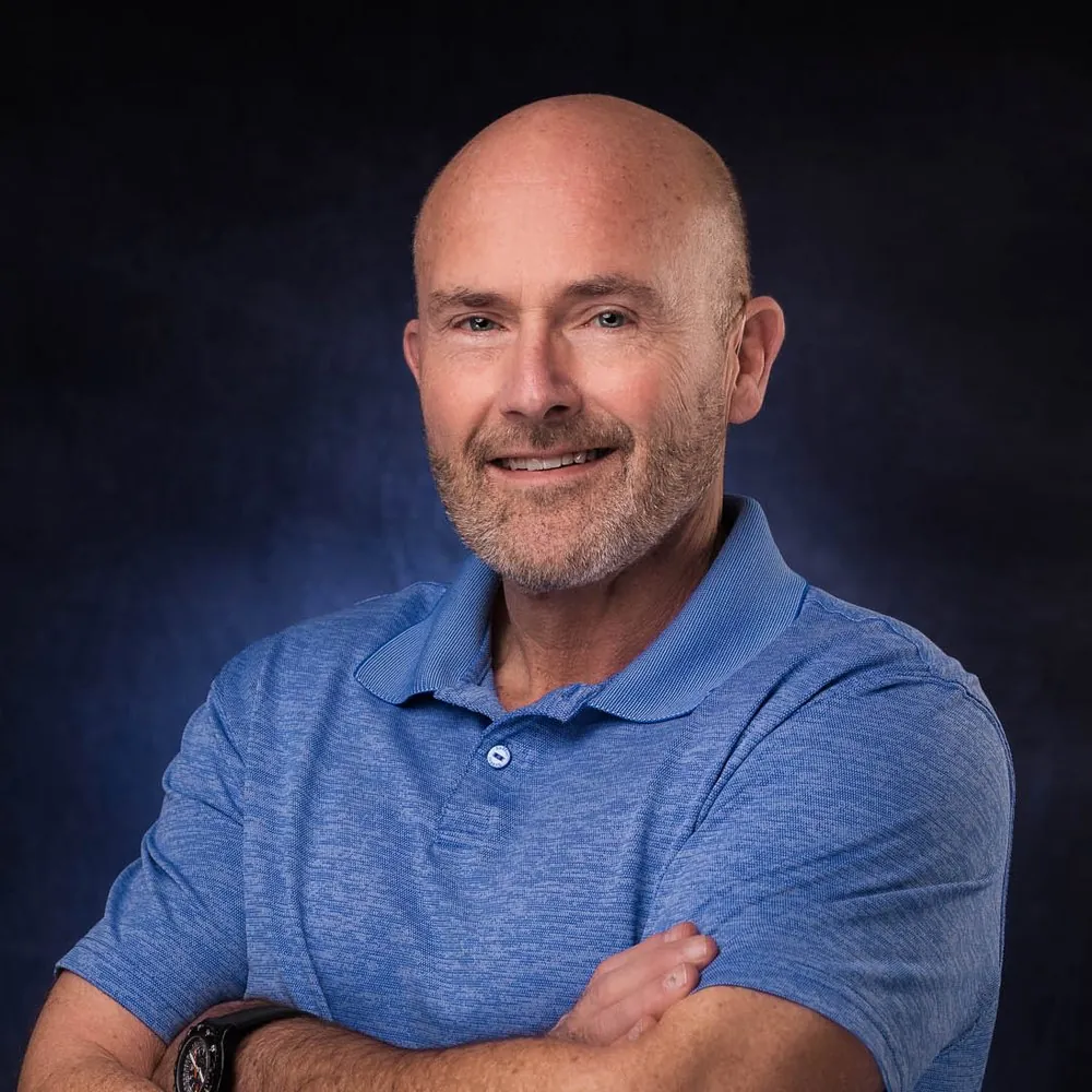 Corporate headshot on a gray backdrop